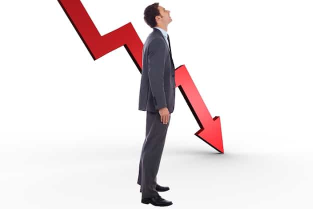 A downward sloping arrow graph highlighting a decrease in interest rates with a confident businessperson standing next to it.