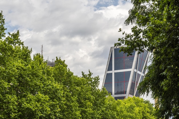 A photograph of a modern, eco-friendly office building with solar panels, representing the growing trend of sustainable and energy-efficient structures.