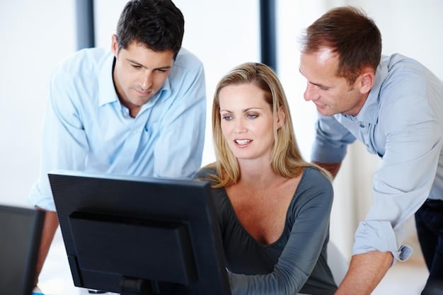 A group of people huddled around a computer screen, reviewing financial projections and funding proposals for their independent film project. The atmosphere is intense but focused, reflecting the dedication required to secure funding.