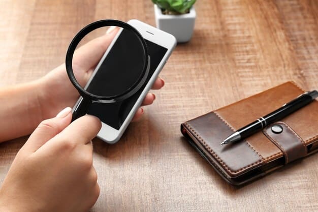 A person using a magnifying glass to examine a smartphone screen displaying a news article, emphasizing the need for close scrutiny and critical analysis.