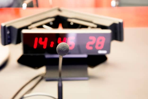 A close-up of the new pitch clock in a baseball stadium, showing the countdown numbers ticking down to zero. The background includes a blurred view of the pitcher and batter in their stances.