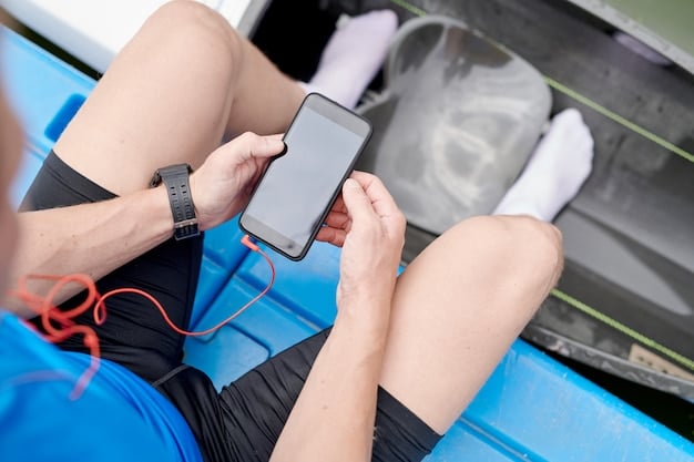 A fitness tracker displaying heart rate data during a HIIT session, showing peaks and valleys that represent intense bursts and recovery periods. The tracker is on an athlete's wrist, with a blurred background of a gym.