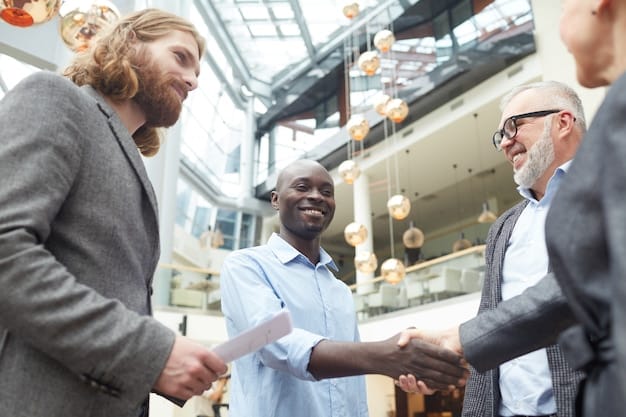 A handshake among diverse professionals representing different stages of a supply chain, symbolizing strong strategic alliances and collaboration.