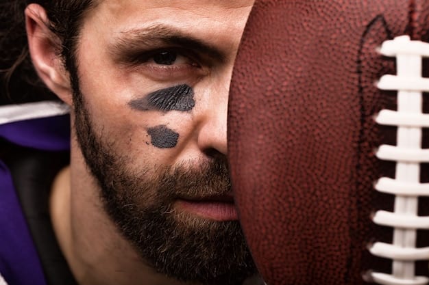 A close-up shot of a determined college football coach on the sidelines, intensely watching the game unfold, emphasizing strategic decision-making.