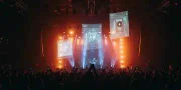 Futuristic concert stage with holographic album art for 2026 music releases